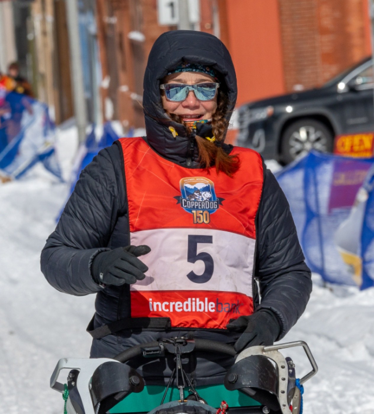 CopperDog 150 musher wearing bib 5 on course in Calumet, Michigan